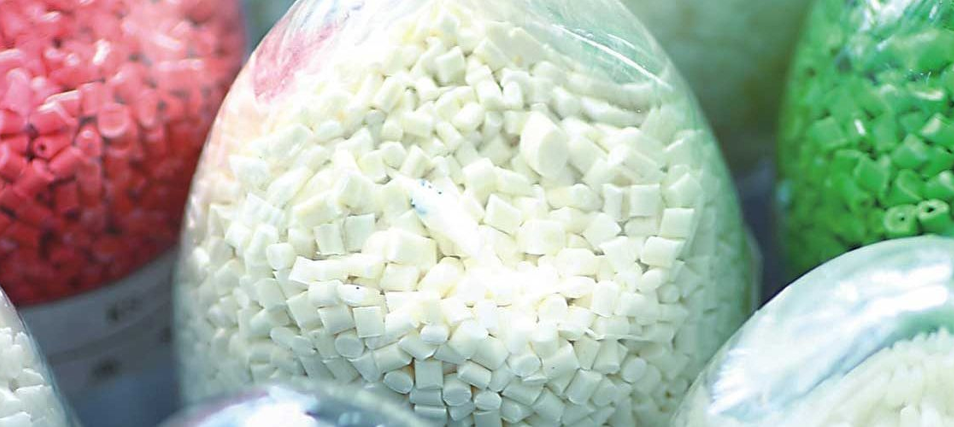 Colorful plastic pellets in transparent bags