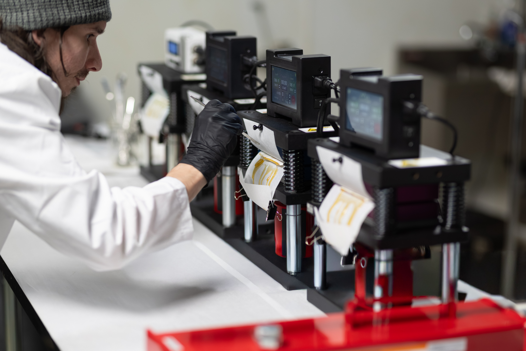 Shot of the process for making live rosin from dry hash and cannabis trichomes. Shot inside of a cannabis processing laboratory in Oregon, USA.